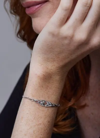Close up shot of red haired model wearing Sterling Silver Double Trinity Knot Drawstring Bracelet